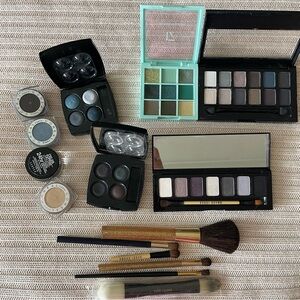 Used and unused eye makeup and brushes.